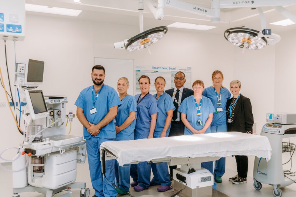 Staff posing for a photograph in the operating room of the ModuleCo operating theatre at Newark Hospital